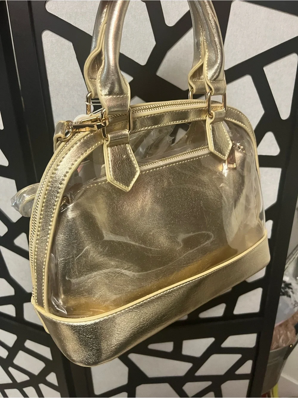 Gold clear two and one purse with handles and gold straps.